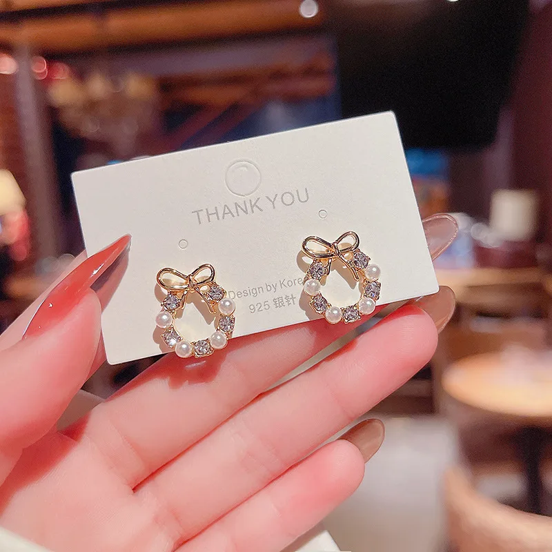 Korean version of the new fashion temperament super fairy hundred matching zircon pearl bow earrings