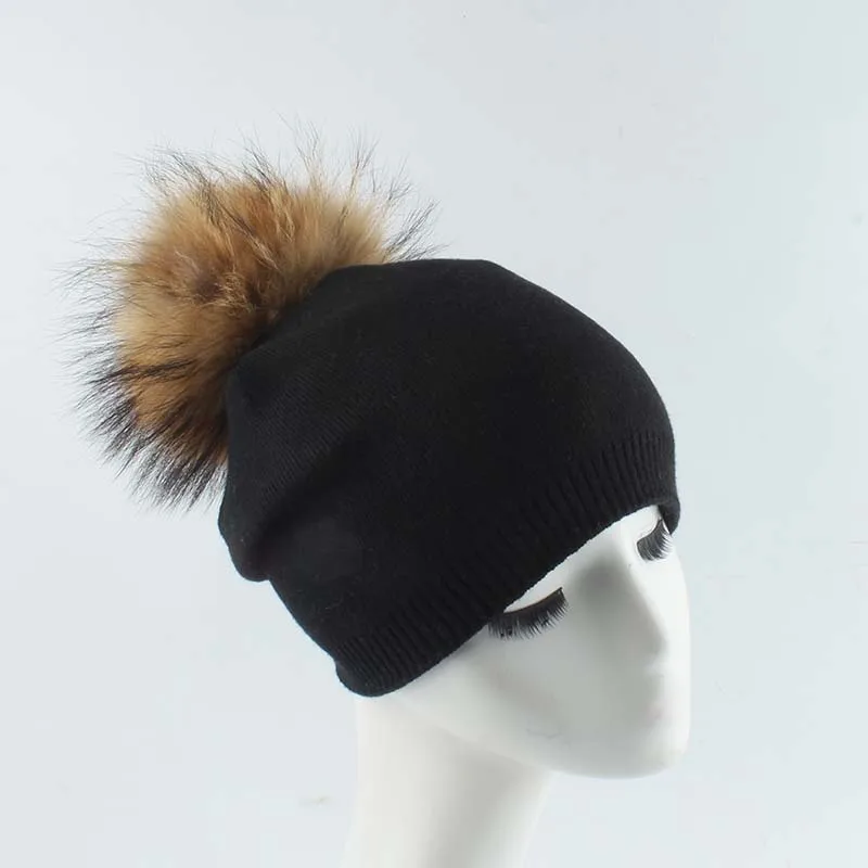 black hat with tan pom pom