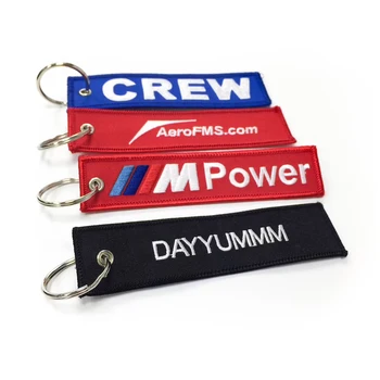 Cheap custom fabric remove before flight key chain key tag both sided logo woven label embroidery key ring