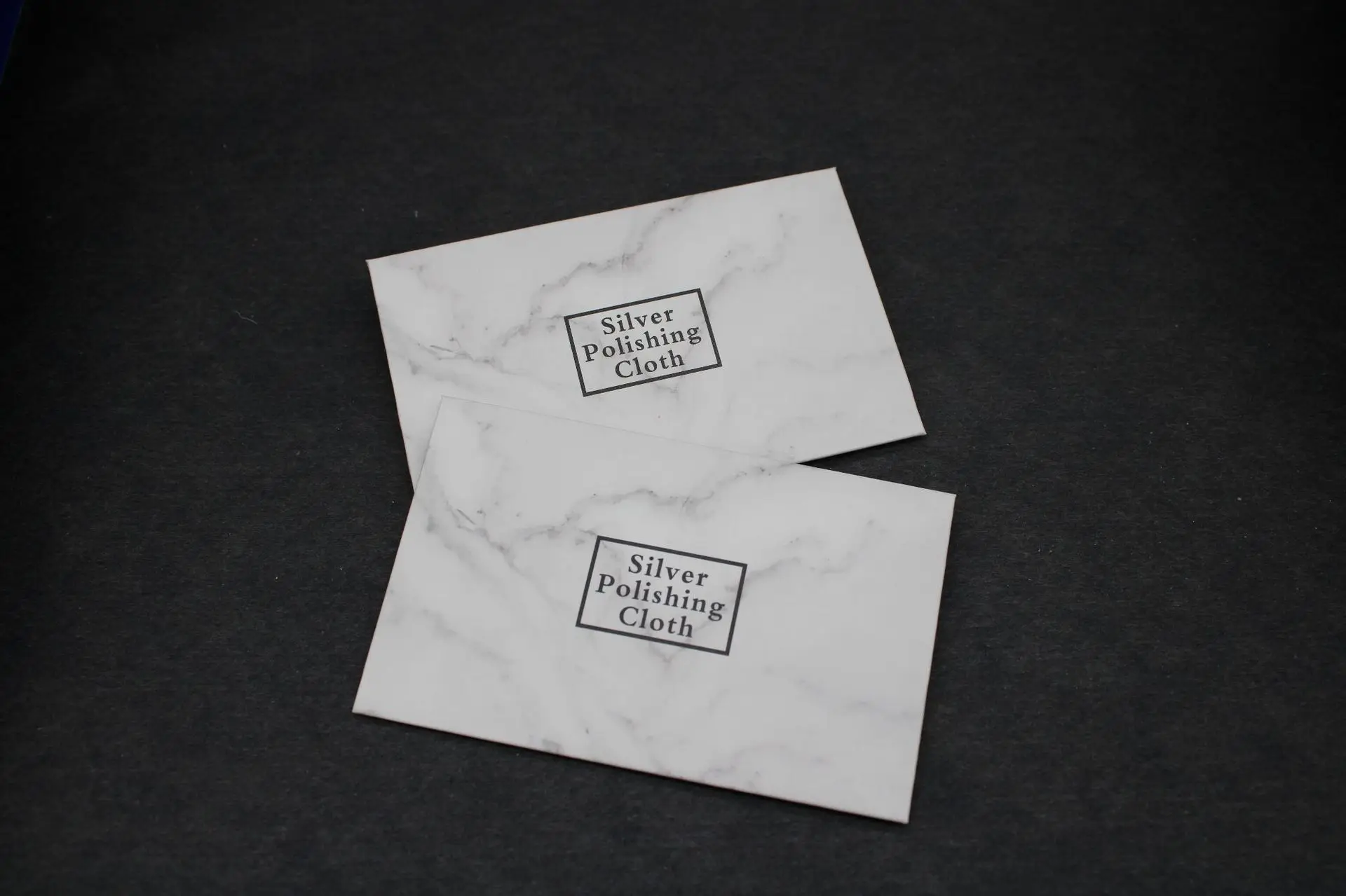 Professional packaging for silver polishing cloth Gray jewelry cleaning cloth in paper packaging for retail distribution