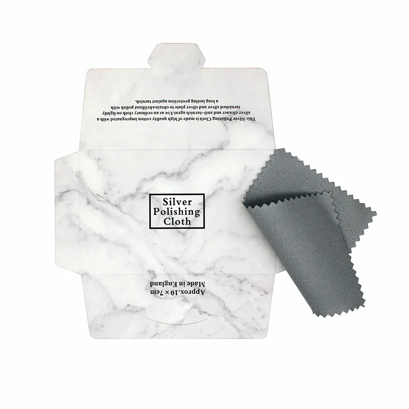 Silver polishing cloth restoring shine to jewelry Sterling silver rings being cleaned with professional polishing cloth