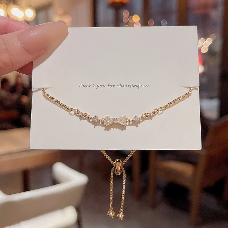 Korean version of the new light luxury matching temperament pull type zircon pearl bow bracelet for women