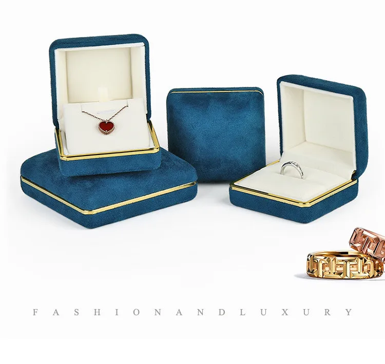 high end blue velvet jewelry box with gold line for ring