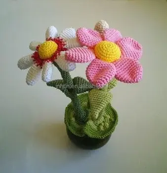 colored handmade crocheted flowers with clay pot