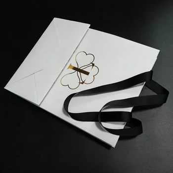 white 250g A4 paper bags with gold foil logo and black ribbon