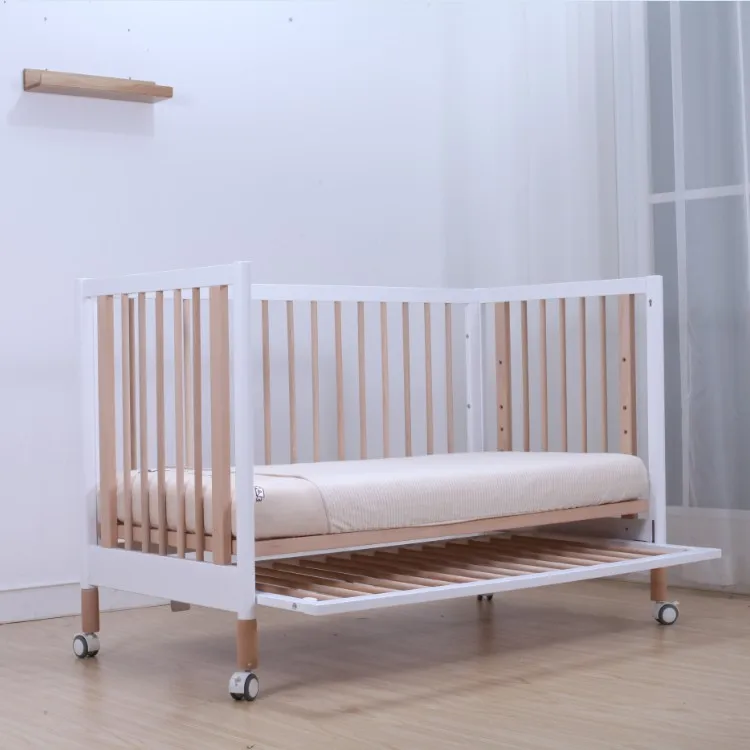 baby cot attached to bed