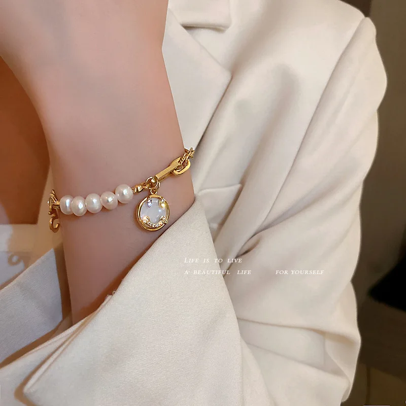 gold bracelet with pearl charm