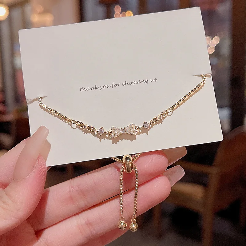 Korean version of the new light luxury matching temperament pull type zircon pearl bow bracelet for women