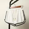 White three-quarter pants