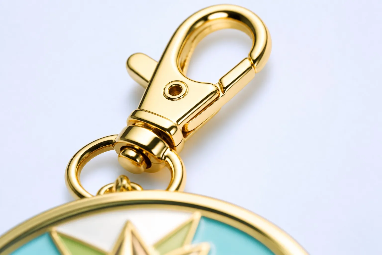 Gold lobster clasp hardware close-up — precision metal clasp mechanism
