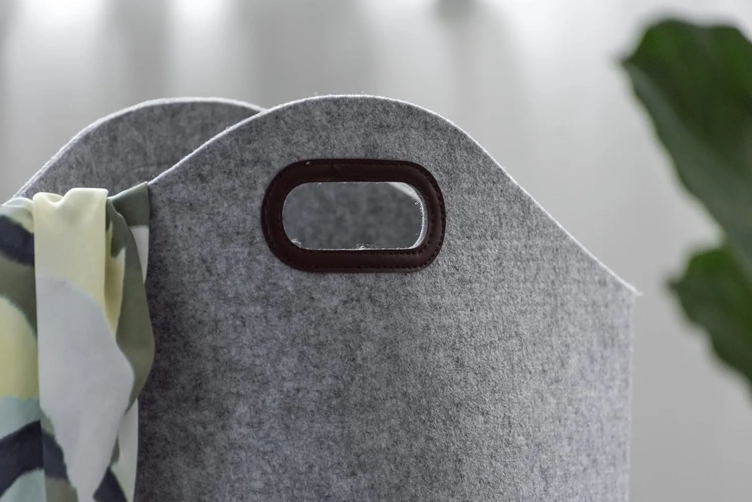 Close-up of the reinforced carry handle on a felt laundry basket