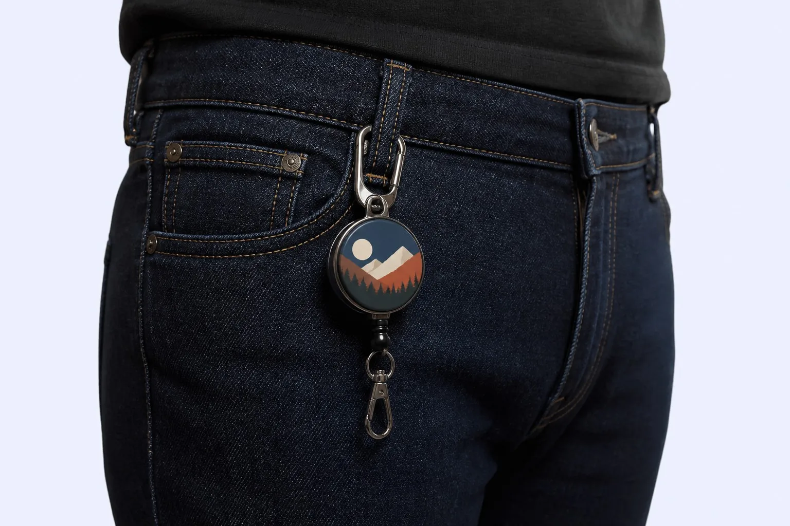 Badge reel keychain clipped to jeans belt loop