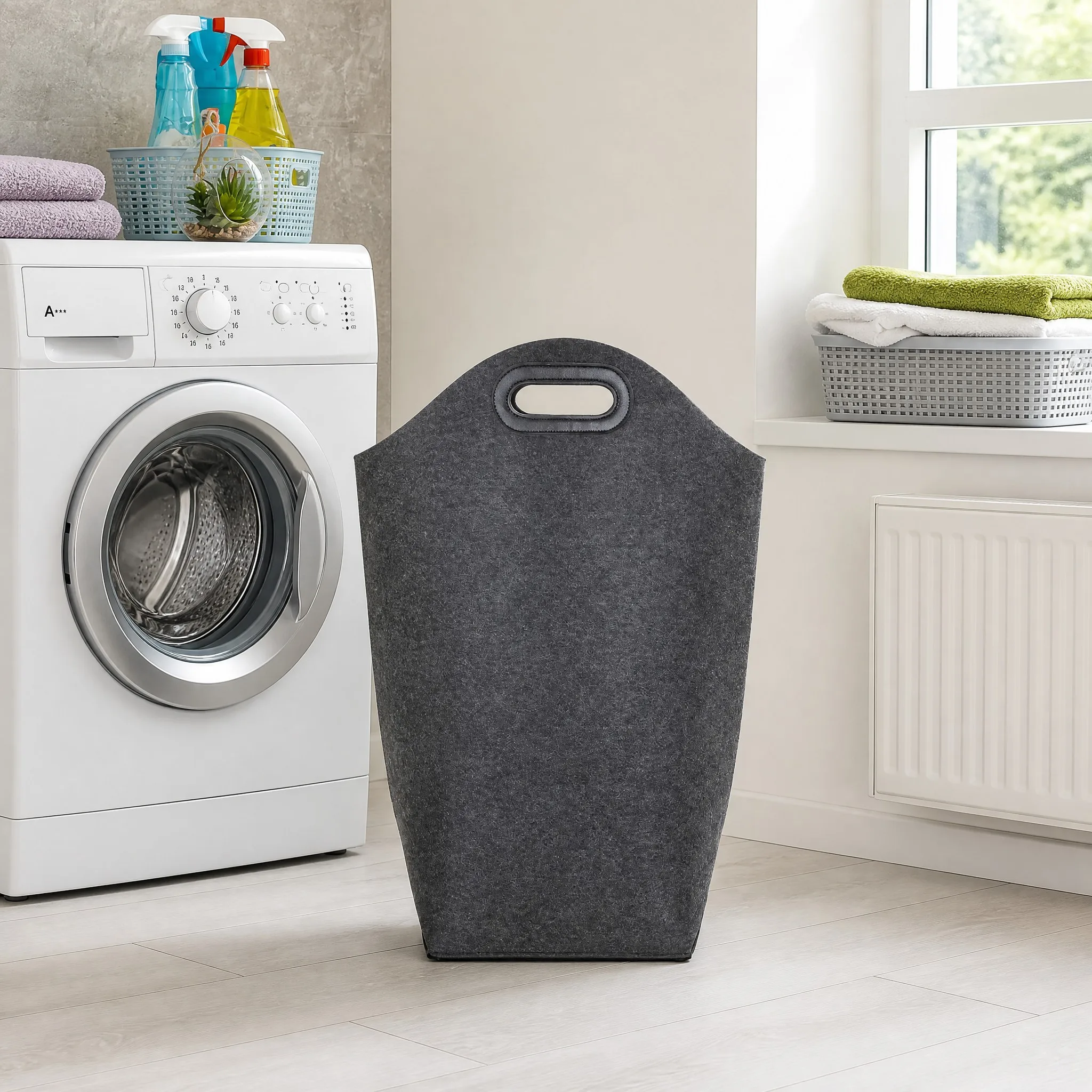 Charcoal felt laundry basket standing near a washing machine