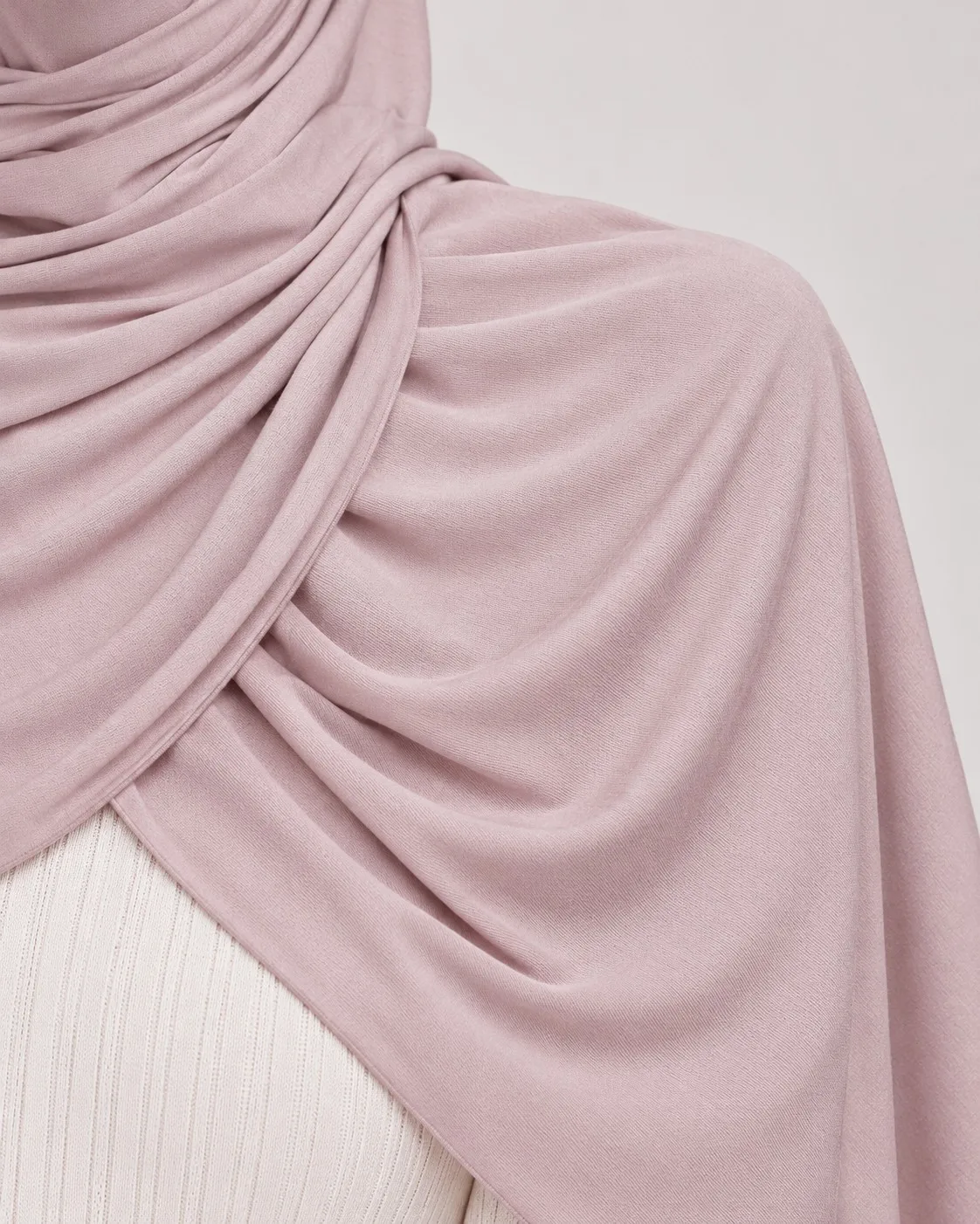 Bamboo jersey hijab fabric drape close-up — dusty rose soft fold and texture detail