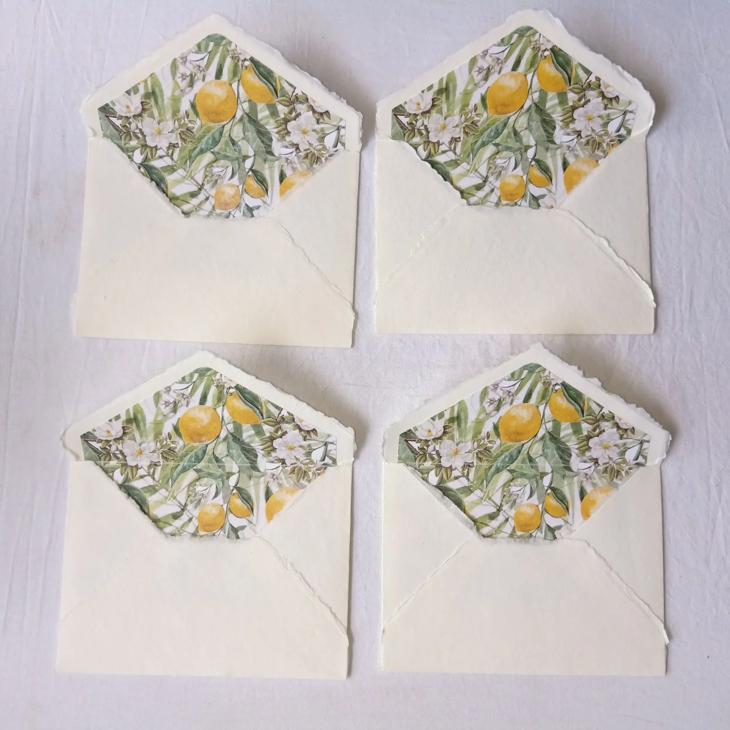 Custom Made Deckle Edged Paper Envelopes with Citrus Themed Liner Suitable for Wedding Stationers