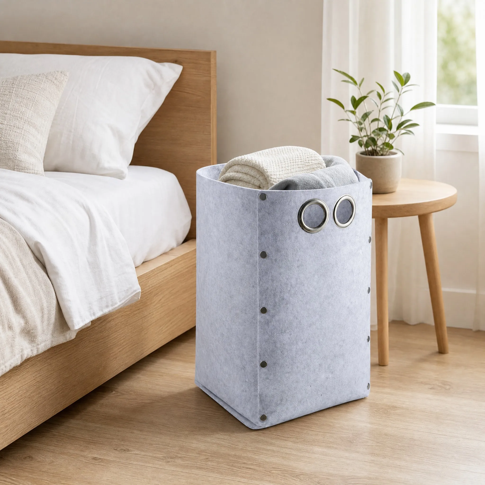 Metal grommet cutout handles on the felt laundry hamper