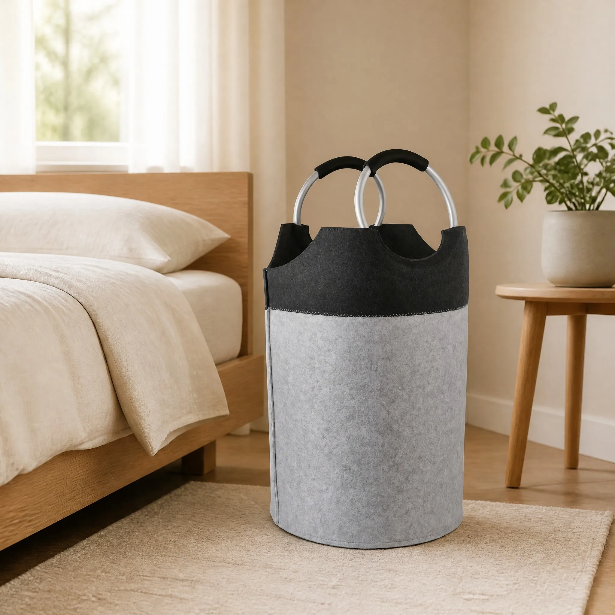 Felt laundry hamper styled beside a bed in a modern bedroom