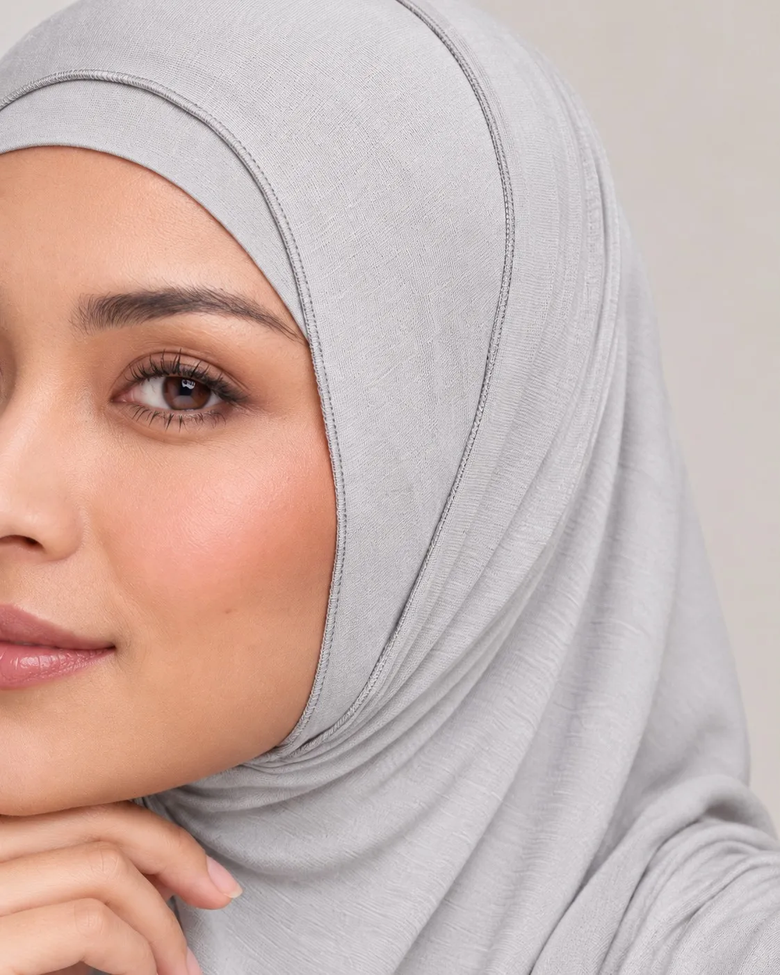Bamboo jersey hijab drape close-up — pearl grey fabric fold and shoulder coverage detail