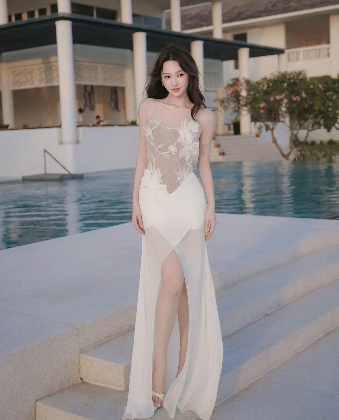 A flowy white chiffon dress with an intricate floral design made in Vietnam