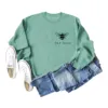 ight green sweatshirt (black font) printed on the chest