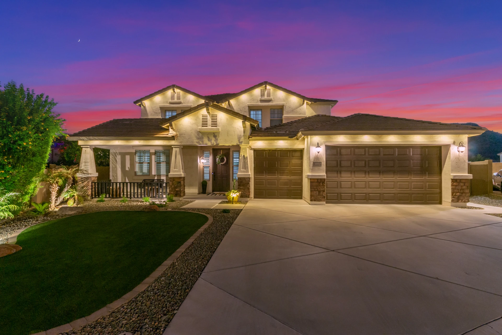 House exterior at sunset with EverGlow accent lighting illuminating the facade