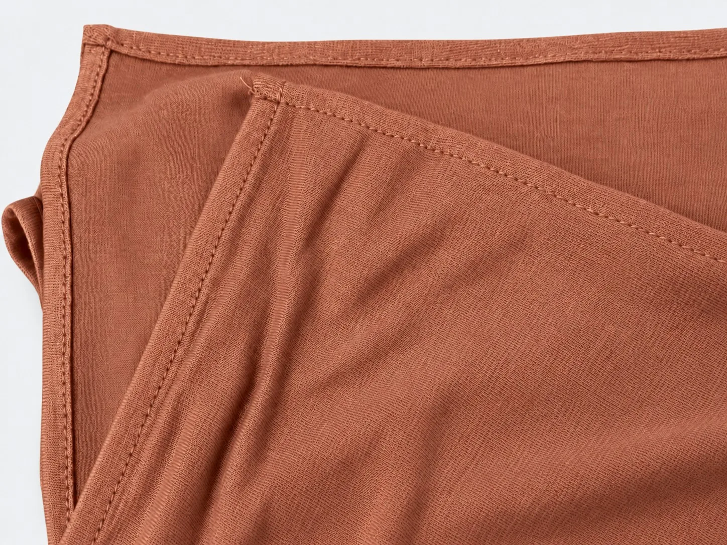 Custom bamboo jersey hijab set flat-lay — matching hijab and underscarf stitch and hem detail