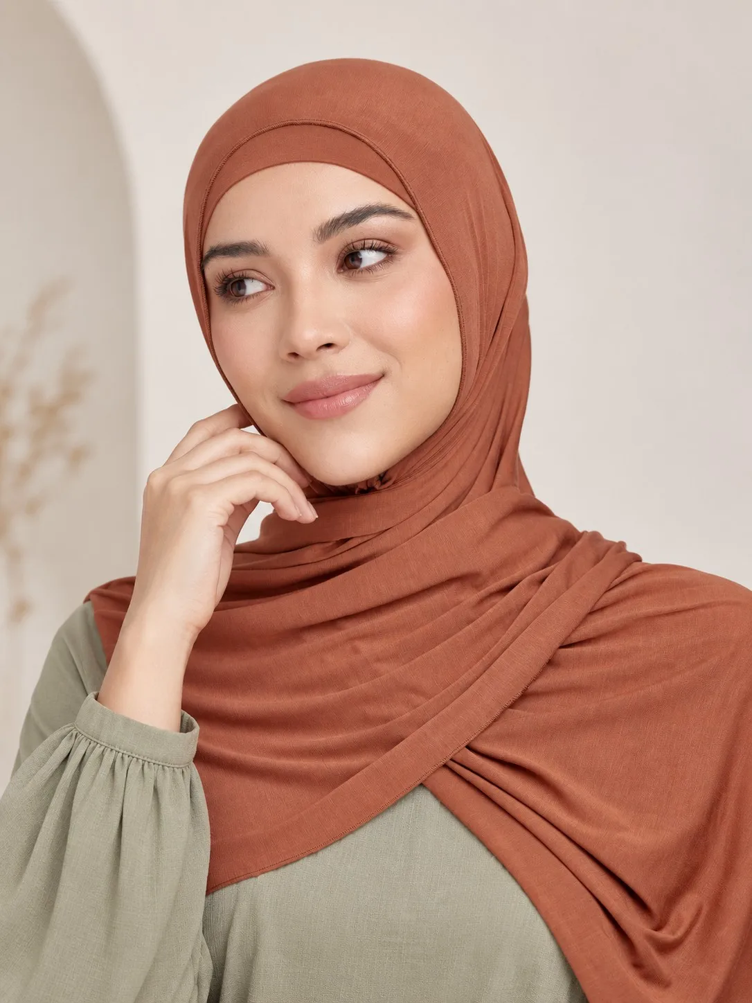 Custom matching bamboo jersey hijab set — two models in terracotta, full set front view