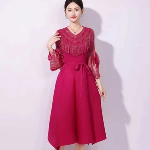 An elegant fringed pleated dress in Africa with gold embroidery and flower-shaped sleeves