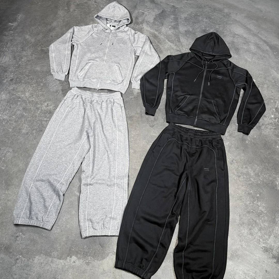 Mandlig amerikansk high-street to-delts sæt, tilpasset enfarvet raglan-hættetrøje med lynlås og broderi, løs strakt sweatpants med brede ben