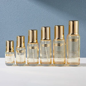 Large Volume 200ml  Glass Bottles Are Used for Cosmetic Packaging the Semi-transparent Yellow Bottle with Gold Screw Cap or Pump