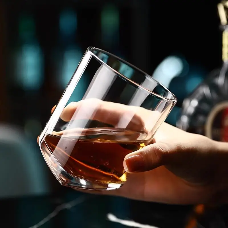 Clear stemless whiskey glass with a rounded lower profile
