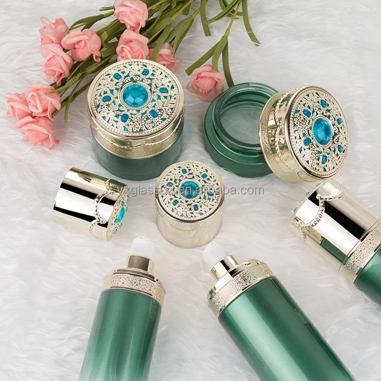 Cosmetic glass bottle set skincare cosmetic packaging glass container with Luxury lid carving craft pump spray cap factory