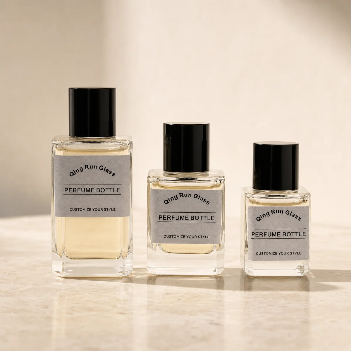Clear Square Glass Perfume Bottles with Black Cylindrical Caps and Printed Labels