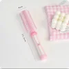 Peine rizador rosa con garra de limpieza
