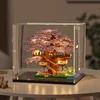Grande boîte lumineuse en forme de cerisier en fleurs violettes.