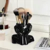 Black pen holder for supporting the face