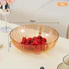 Round, luxurious fruit platter featuring transparent oranges.