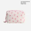 Bolsa almohada con lazo rosa y blanco.