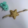 Cerchietto dorato con grande stella a cinque punte