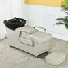 Grayish-white bed with black porcelain basin