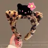 Fascia per capelli con fiore rosa e decorazione a forma di gatto