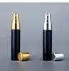 Black bottle with gold sprayer