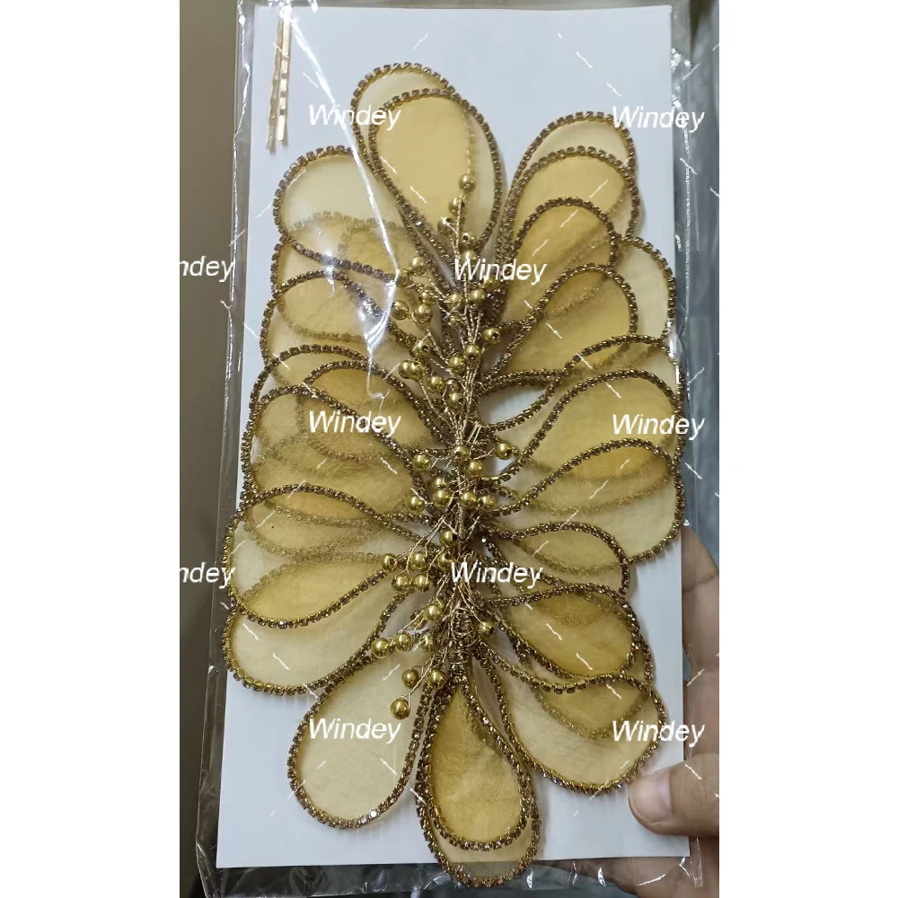 stone design on dress Black evening dress with emptied oval bustier in the middle and delimited with Swarovski crystals and floral stone design. Emptied on the waist as well on the back with a circular shape