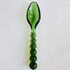 Green glass bead spoon