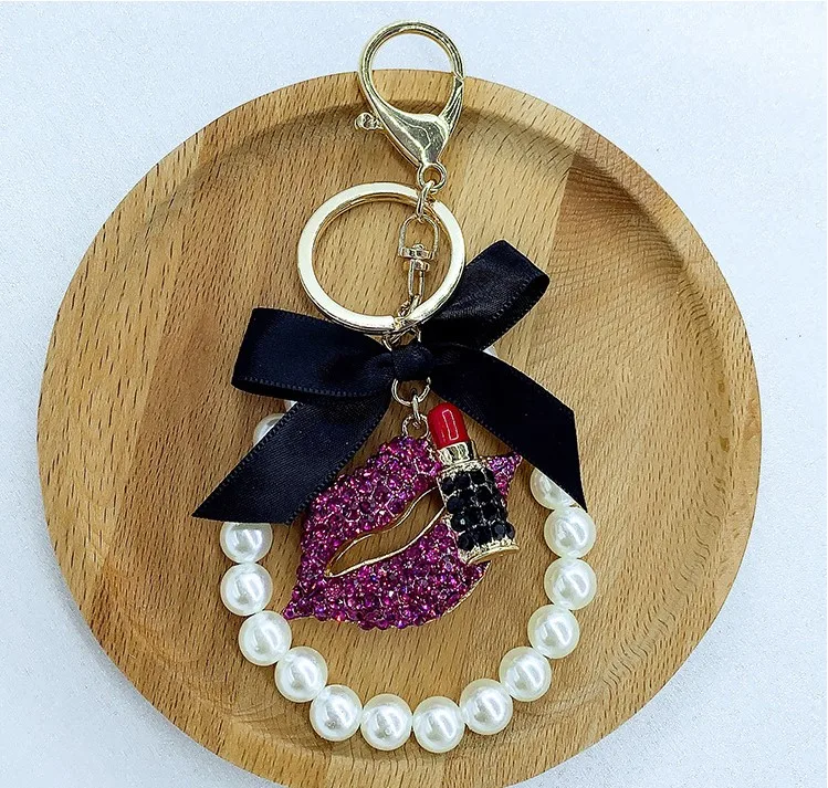 Wholesale Women Pearl Flower Charm Key Chain Strap Lipstick Bottle