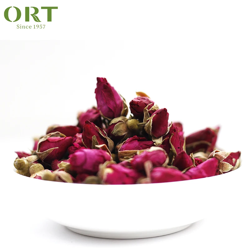 Herbal tea with red peony flower rose bud petals-