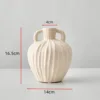 One unglazed small jar