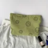 Green smiley face storage bag