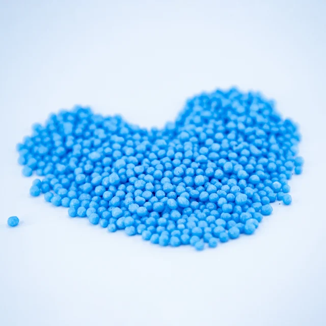 Urea coating used to improve compatibility in end uses