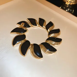 Vintage Style Gold Tone Bracelet with Black Enamel Accents Retro Statement Jewelry for Women Elegant Eye-Catching Accessory
